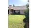 Backyard features a well-maintained lawn, lush landscaping, and covered patio at 420 N Leoma Ln, Chandler, AZ 85225
