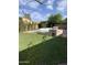 Inviting backyard features a well-maintained lawn, a sparkling pool, a built-in barbeque and privacy landscaping at 420 N Leoma Ln, Chandler, AZ 85225