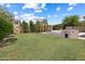 Large backyard featuring green lawn, mature trees and a block wall for privacy at 420 N Leoma Ln, Chandler, AZ 85225