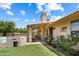 Charming backyard featuring a covered patio, outdoor grill, lush green lawn, and vibrant flowers at 420 N Leoma Ln, Chandler, AZ 85225