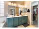 Well-lit bathroom with double sink vanity and an adjacent walk-in closet at 420 N Leoma Ln, Chandler, AZ 85225