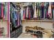 Walk-in closet featuring built-in shelving, drawers, and ample hanging space for organized storage at 420 N Leoma Ln, Chandler, AZ 85225