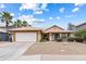 Charming single-story home with desert landscaping, a two-car garage, and palm trees in a desirable location at 420 N Leoma Ln, Chandler, AZ 85225