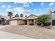 Charming single-story home with desert landscaping, a two-car garage, and palm trees in a desirable location at 420 N Leoma Ln, Chandler, AZ 85225