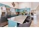 Modern kitchen boasts stylish blue cabinets, stainless steel appliances, and a spacious island with bar seating at 420 N Leoma Ln, Chandler, AZ 85225