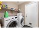 Functional laundry room with modern appliances, storage shelves, and convenient access at 420 N Leoma Ln, Chandler, AZ 85225