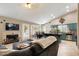 Open floor plan with a living room featuring a fireplace and seamless flow into a breakfast nook and kitchen at 420 N Leoma Ln, Chandler, AZ 85225