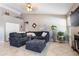 Cozy living room featuring vaulted ceiling, tile flooring, a fireplace, and a comfortable sectional sofa at 420 N Leoma Ln, Chandler, AZ 85225