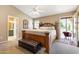 Spacious main bedroom with vaulted ceiling, carpet, backyard access and ensuite bathroom at 420 N Leoma Ln, Chandler, AZ 85225