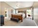 Spacious main bedroom with vaulted ceiling, carpet, backyard access and ensuite bathroom at 420 N Leoma Ln, Chandler, AZ 85225