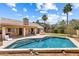 Beautiful backyard pool with spacious patio, outdoor kitchen, and lush landscaping creating a private oasis at 420 N Leoma Ln, Chandler, AZ 85225