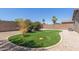 A backyard with gravel landscaping, artificial grass, and shrubbery at 42347 W Bunker Dr, Maricopa, AZ 85138