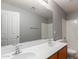 Bathroom featuring a double vanity, large mirror, and a shower-tub combination at 42347 W Bunker Dr, Maricopa, AZ 85138