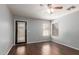 Cozy bedroom features a ceiling fan and private outdoor access to the yard at 42347 W Bunker Dr, Maricopa, AZ 85138