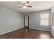 Cozy bedroom with ceiling fan and two windows for ample natural light at 42347 W Bunker Dr, Maricopa, AZ 85138