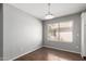 Bright dining room features wood floors and natural light from a large window at 42347 W Bunker Dr, Maricopa, AZ 85138