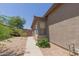 Exterior shot of home featuring gravel landscaping and privacy wall at 42347 W Bunker Dr, Maricopa, AZ 85138