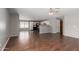 Spacious living area with beautiful hardwood floors, neutral paint, and ample room for entertaining at 42347 W Bunker Dr, Maricopa, AZ 85138