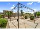 Spacious backyard patio with desert landscaping, featuring a covered seating area, ideal for outdoor gatherings at 43787 W Colby Dr, Maricopa, AZ 85138
