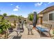 Inviting backyard patio with seating, fire pit, and desert landscaping for outdoor relaxation and entertainment at 43787 W Colby Dr, Maricopa, AZ 85138