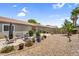 Spacious backyard with desert landscaping, a covered patio, and plenty of room for outdoor activities at 43787 W Colby Dr, Maricopa, AZ 85138