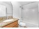 Bright bathroom featuring updated vanity, granite countertop, and shower-tub combo at 43787 W Colby Dr, Maricopa, AZ 85138