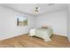 Well-lit bedroom featuring tile floor, bright window, and neutral tones at 43787 W Colby Dr, Maricopa, AZ 85138