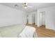 Bright main bedroom with natural light, ceiling fan, and ensuite bath at 43787 W Colby Dr, Maricopa, AZ 85138