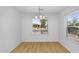 An empty dining room with hardwood floors and natural light through the large window at 43787 W Colby Dr, Maricopa, AZ 85138