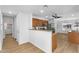 Cozy kitchen with wooden cabinets, stainless steel appliances, breakfast bar, and adjacent dining area at 43787 W Colby Dr, Maricopa, AZ 85138