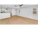 Bright and airy living room with wood-look tile flooring and a ceiling fan at 43787 W Colby Dr, Maricopa, AZ 85138