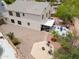Backyard aerial view showcasing outdoor seating area with patio, desert landscaping, and a fire pit at 44890 W Desert Garden Rd, Maricopa, AZ 85139