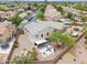 Bird's-eye view of home with fenced yard, patio, fire pit, desert landscaping, and surrounding neighborhood at 44890 W Desert Garden Rd, Maricopa, AZ 85139