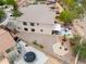 Aerial view of the home showcasing the backyard featuring a patio, fire pit, desert landscaping, and fenced yard at 44890 W Desert Garden Rd, Maricopa, AZ 85139