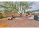 Spacious backyard featuring desert landscaping, covered patio and outdoor seating area, perfect for relaxing at 44890 W Desert Garden Rd, Maricopa, AZ 85139