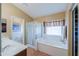 Bathroom featuring a double vanity, walk-in shower, and luxurious soaking tub at 44890 W Desert Garden Rd, Maricopa, AZ 85139