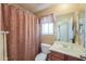 Full bathroom with patterned shower curtain, mirror and vanity at 44890 W Desert Garden Rd, Maricopa, AZ 85139