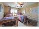 Bedroom featuring two beds, ceiling fan, and coordinated decor at 44890 W Desert Garden Rd, Maricopa, AZ 85139