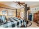 Bedroom featuring a four-poster bed, ceiling fan, and modern decor at 44890 W Desert Garden Rd, Maricopa, AZ 85139