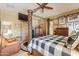 Bright primary bedroom featuring a four-poster bed, natural light, and decor at 44890 W Desert Garden Rd, Maricopa, AZ 85139