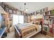 Bedroom filled with books, artwork, and a large window with natural light at 44890 W Desert Garden Rd, Maricopa, AZ 85139