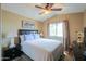 Comfortable bedroom featuring a ceiling fan and a large window at 44890 W Desert Garden Rd, Maricopa, AZ 85139
