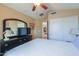 Cozy bedroom with a large mirror and neutral paint color at 44890 W Desert Garden Rd, Maricopa, AZ 85139
