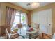 Bright breakfast nook featuring a glass table set and natural light streaming through the window at 44890 W Desert Garden Rd, Maricopa, AZ 85139