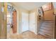 Inviting entryway showcasing a staircase, tiled flooring, and convenient access to the home's interior at 44890 W Desert Garden Rd, Maricopa, AZ 85139