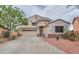 Charming two-story home featuring a three-car garage and desert landscaping at 44890 W Desert Garden Rd, Maricopa, AZ 85139