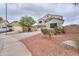 Charming two-story home featuring a three-car garage and desert landscaping at 44890 W Desert Garden Rd, Maricopa, AZ 85139