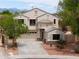 Charming two-story home featuring a desert landscape, a three-car garage, and a well-manicured front yard at 44890 W Desert Garden Rd, Maricopa, AZ 85139
