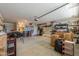 Functional garage space with concrete floor, storage shelving, and overhead door at 44890 W Desert Garden Rd, Maricopa, AZ 85139
