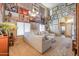 Spacious living room showcasing a large sofa, high ceiling, and plentiful natural light at 44890 W Desert Garden Rd, Maricopa, AZ 85139